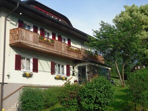 A two-story building with a balcony, a sign reading 'HAUS ELISABETH,' and a number '161.'