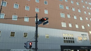 A multi-story hotel with a prominent 'STORIA HOTEL' sign on the top. - Shiroko Storia Hotel (Suzuka)