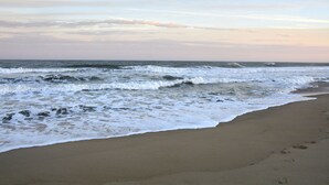 A beach with waves crashing onto the shore. - Bay Front Condo-2br/2ba , Pool, Hot Tub, Lr Balcony W/ Beautiful Sunsets, WIFI.  (Ocean City)
