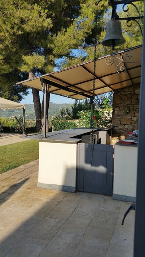 Enjoy al fresco dining on the patio, where a barbecue station and retractable awning create the perfect outdoor space.