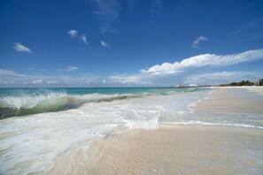 A beach with clear skies and waves.