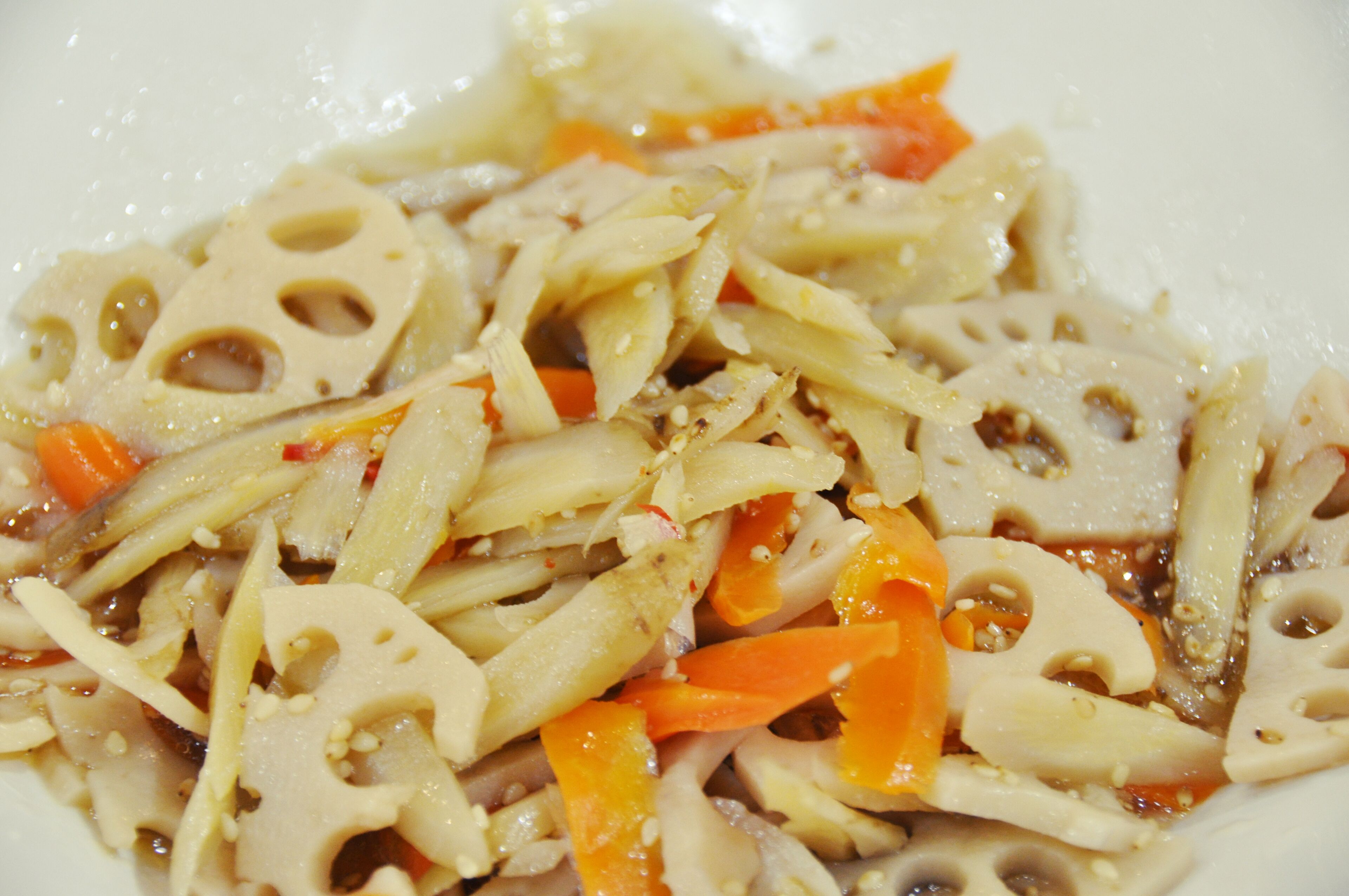 A close-up of a dish with sliced vegetables and tofu.