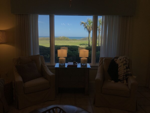 A room with two armchairs, a small table, and a view of the sea. - AMAZING OCEANFRONT AMELIA ISLAND POPULAR LOCATIONSEA GLASS COTTAGE* (Fernandina Beach)