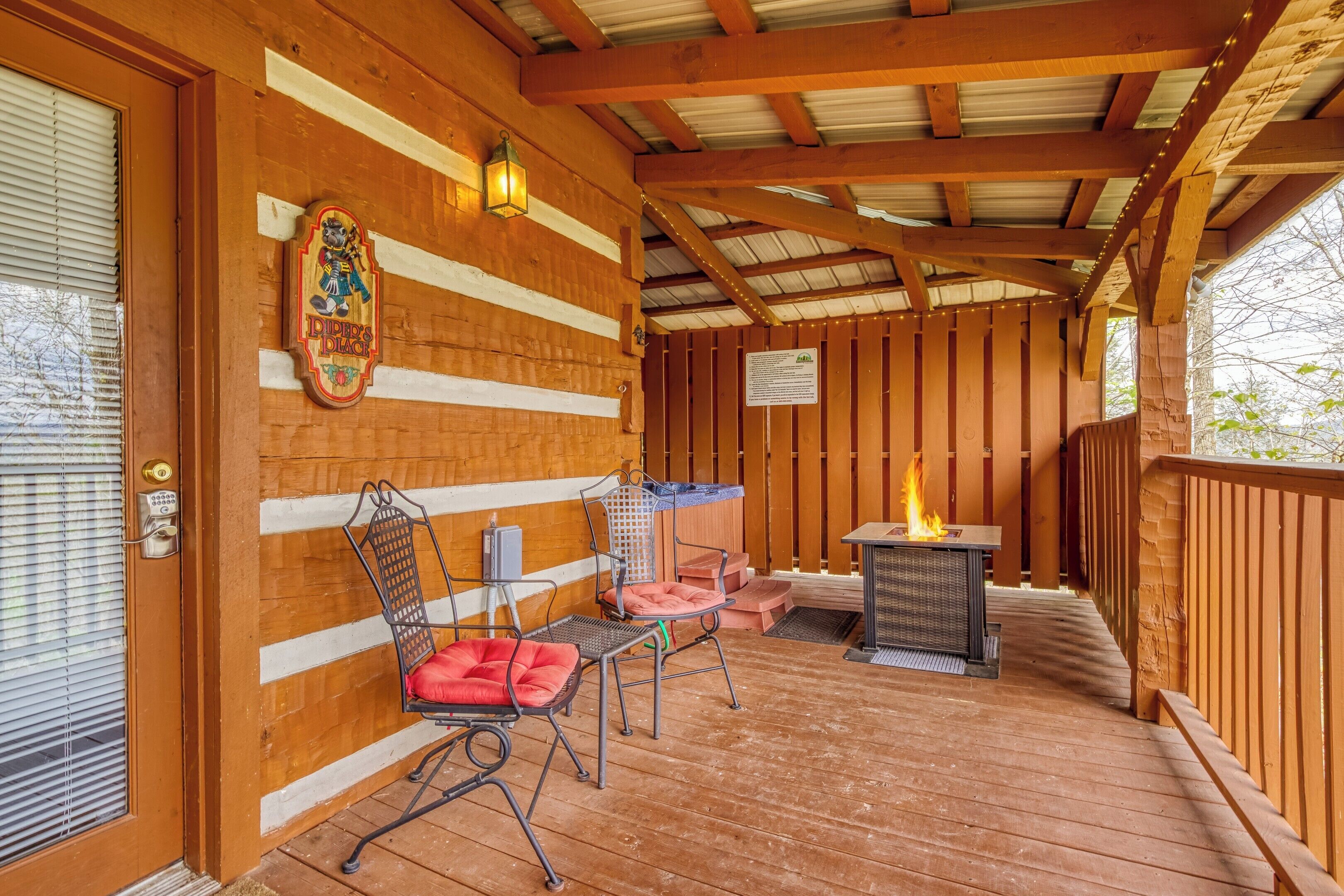 A wooden deck with a fire pit, metal chairs, and a bench.