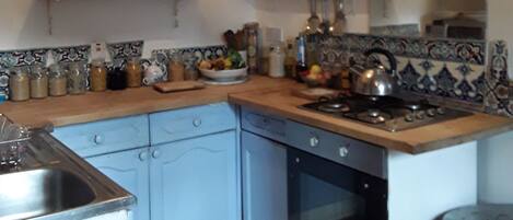 Fridge, microwave, coffee/tea maker, cookware/dishes/utensils