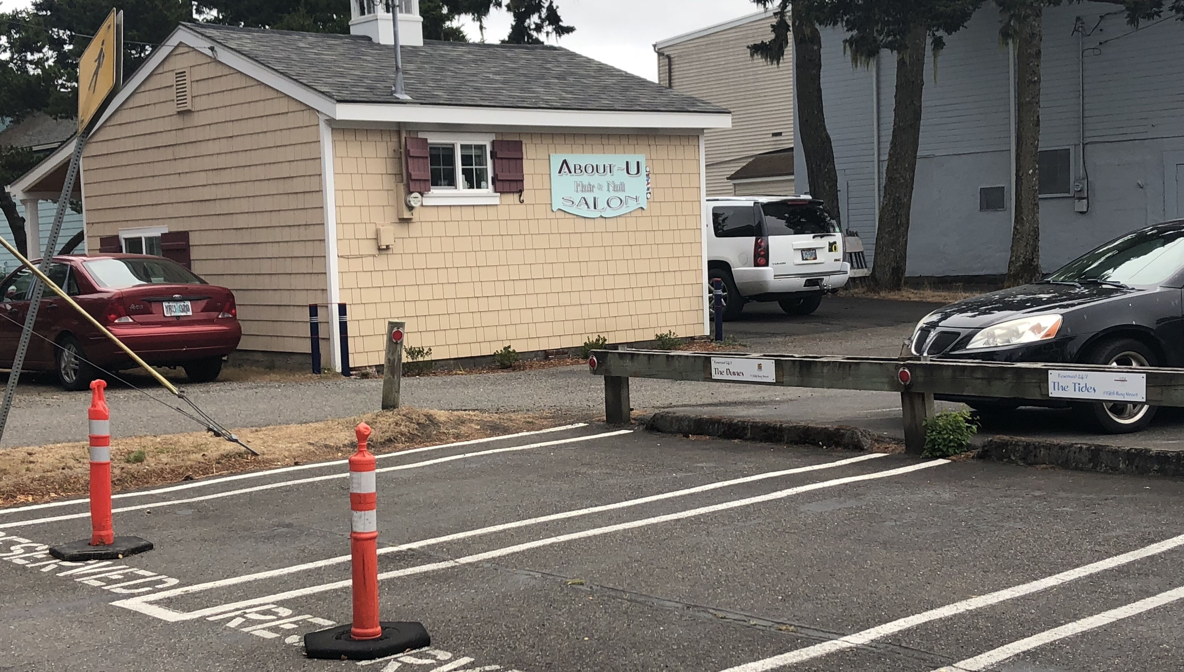 A small building with a sign that reads 'About U Hair & Nail Salon.'