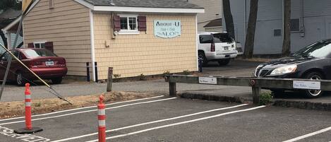 A small building with a sign that reads 'About U Hair & Nail Salon.'