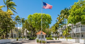 Stroll through a serene coastal setting, surrounded by lush greenery and a charming gazebo.
