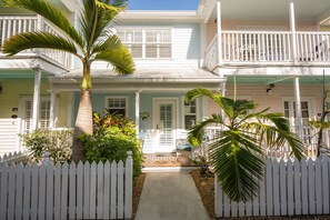 Stroll up to this charming two-story home with a welcoming front porch and lush garden.