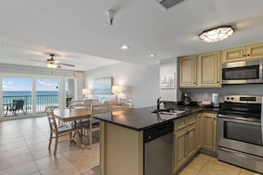 A spacious kitchen with a large island, stainless steel appliances, and a view to the outside. - SEAS THE DAY, Your Happy Place! 208- Destin Seafarer (Destin)