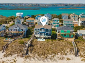 Enjoy ocean access from your beachfront home, featuring outdoor seating areas, a pool, and a well-maintained garden.