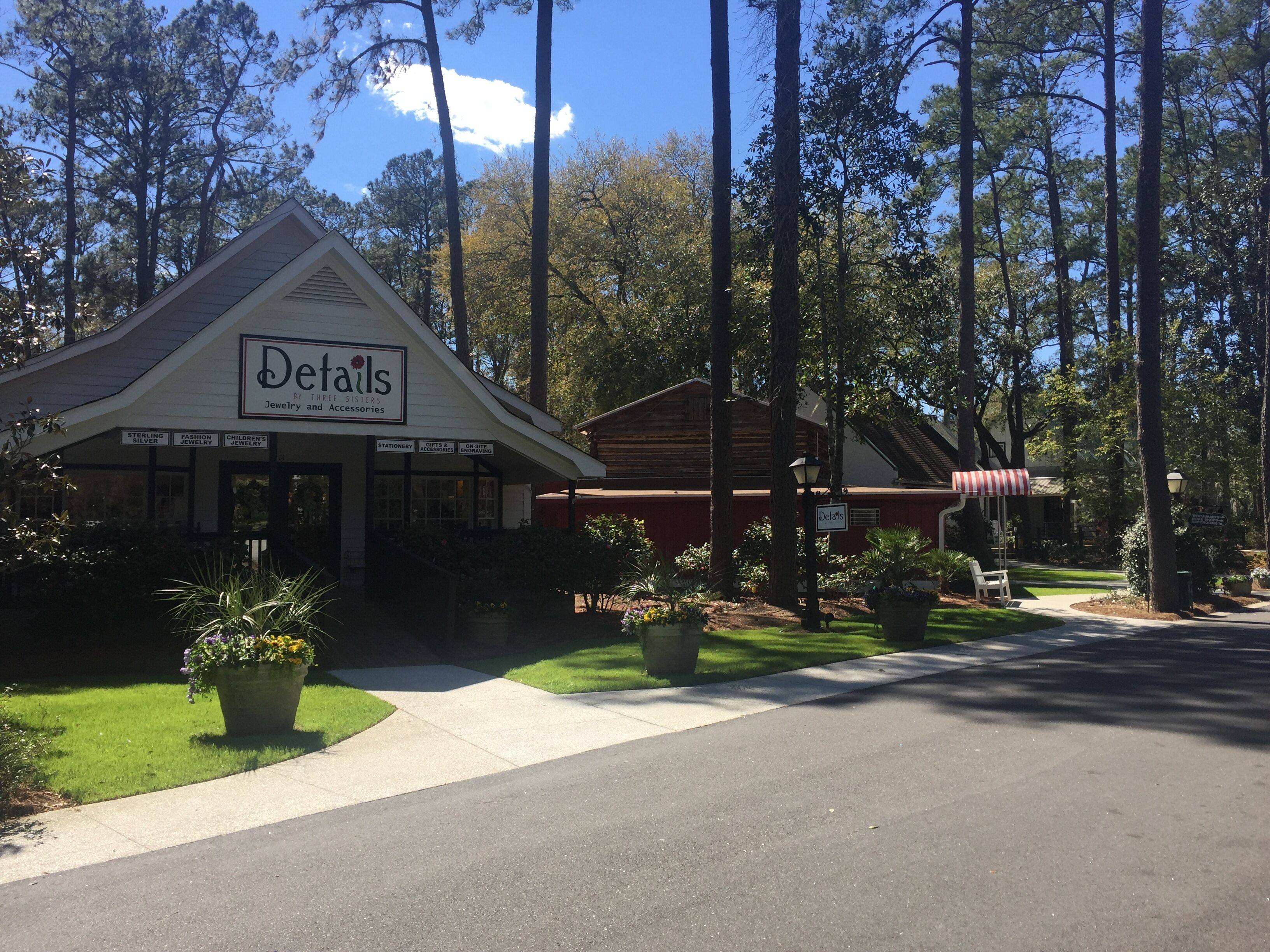 A storefront named 'Details' with a sign indicating it offers jewelry and accessories.