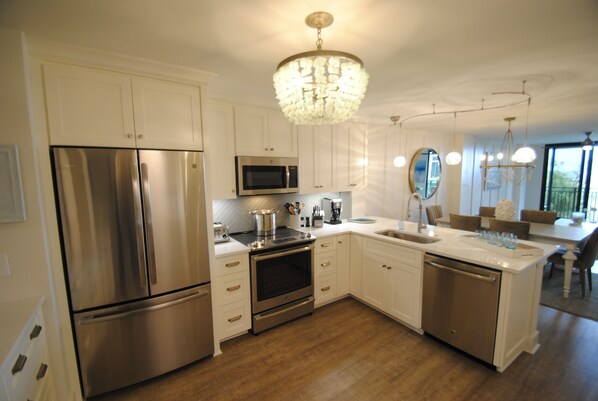 Enjoy cooking in this well-equipped kitchen with a central island and stainless steel appliances.