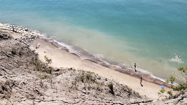 A beach with rocky terrain and a clear view of the ocean. - Hot tub, EV friendly, main floor primary suite with plenty of space. (South Haven)