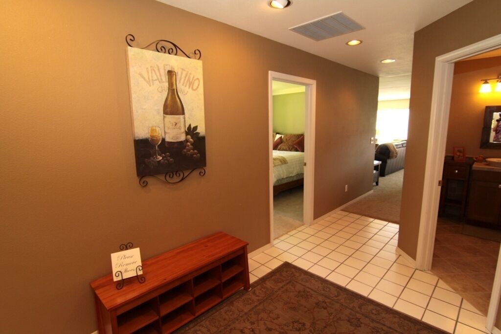 Open entry into condo, laundry room and bathroom off to the right.