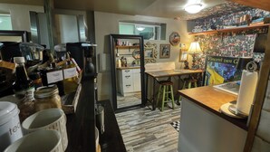 A kitchen with a coffee machine, a sink, and various kitchen items.