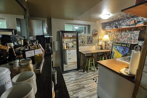 A kitchen with a coffee machine, a sink, and various kitchen items.