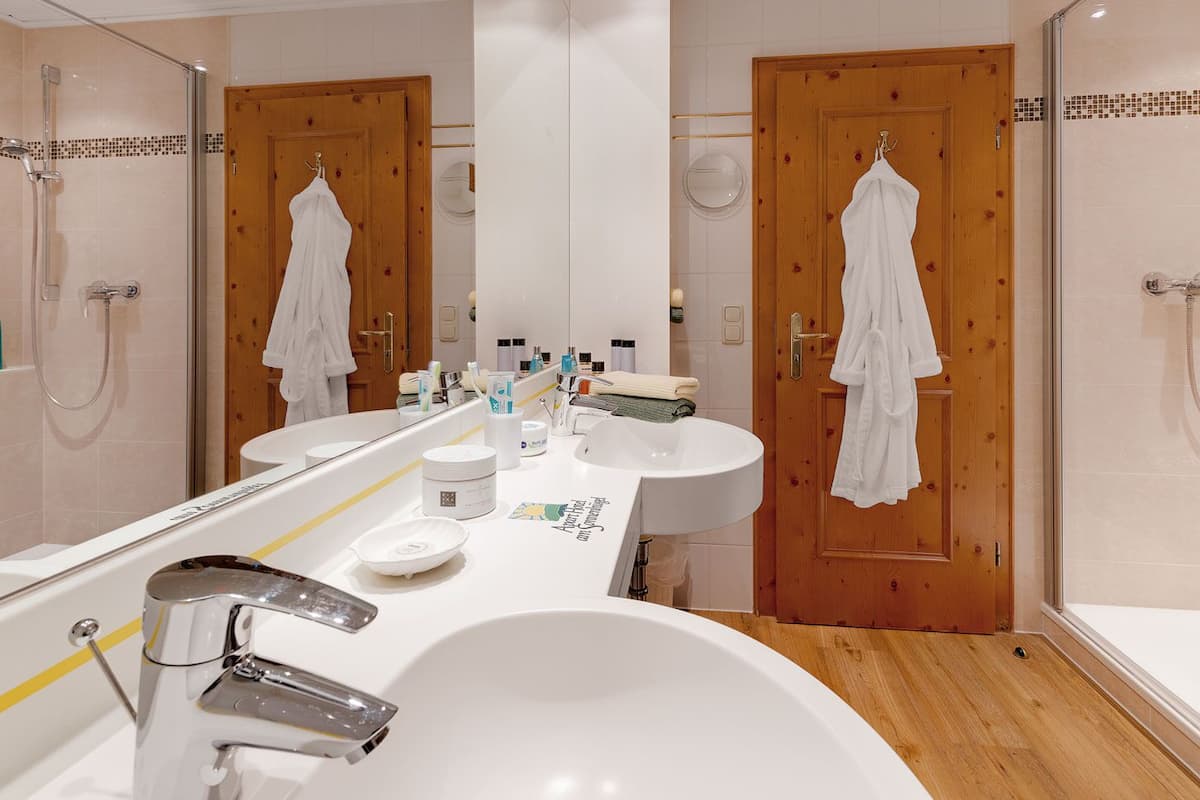 Shower, hair dryer, slippers, towels