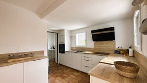 A compact kitchen with white cabinets, a wooden countertop, a built-in oven, and a window providing natural light. - House for 6 people in the Valcros estate with a shared pool (LA LONDE LES MAURES)