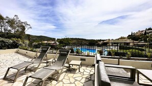 A rooftop pool area with lounge chairs and a view of a swimming pool. - House for 6 people in the Valcros estate with a shared pool (LA LONDE LES MAURES)