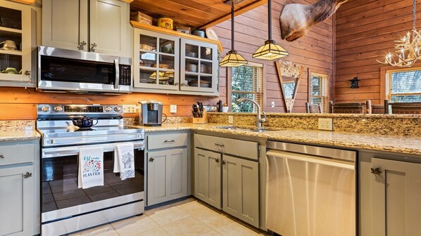 Enjoy cooking in this well-equipped kitchen with a microwave, oven, and dishwasher.