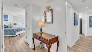 A hotel room with a bed, a desk, a mirror, and a view of the ocean. - Free Beach Svc=2 Chairs/1 Umbrella! Awesome Views! Free Beach Bonfires M/F nts (Miramar Beach)