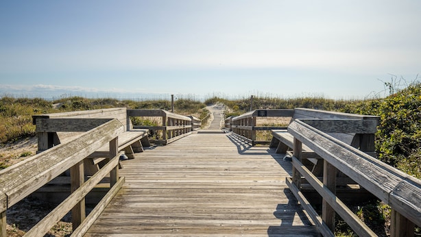 A wooden boardwalk leading to a beach with a clear sky. - GORGEOUS OCEAN FRONT MULTI LEVEL CONDOMINIUM! (Atlantic Beach)