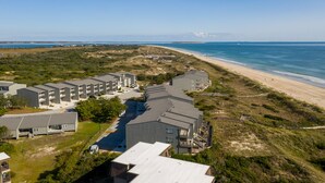 A coastal hotel with multiple buildings, a beach, and a clear view of the ocean. - GORGEOUS OCEAN FRONT MULTI LEVEL CONDOMINIUM! (Atlantic Beach)