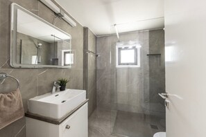 A bathroom with a mirror, sink, shower, and a window. - Villa Mylos 7 is located in the absolute center of Protaras (Protaras)
