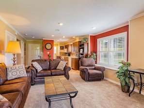 Relax in this inviting living space with a comfortable sofa, armchair, and coffee table.