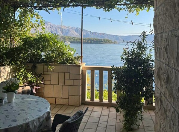 A balcony with a view of a lake and mountains.