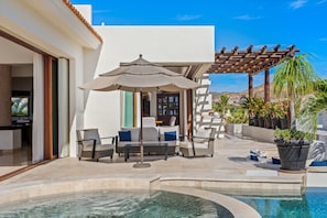 A pool area with a pergola, outdoor seating, and a view of the surrounding landscape. - Casa Bella 5BR | Unobstructed Ocean Views, Pool & Concierge (San Jose del Cabo)