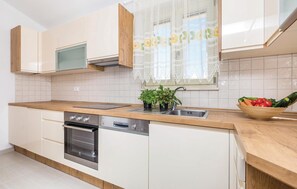 Fridge, stovetop, dishwasher, coffee/tea maker