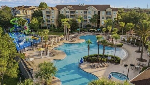A resort with a large swimming pool, a water park, and multiple hotel buildings. - Olaf's Endless Summer at Windsor Hills (Kissimmee)