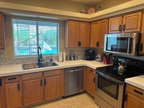 Enjoy cooking in this well-equipped kitchen with a dishwasher, coffee maker, kettle, and microwave.