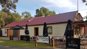 A coffee roasters cafe with outdoor seating and umbrellas. - Adelaide Style Accommodation - Getaway-Close to City In elite North Adelaide (North Adelaide)