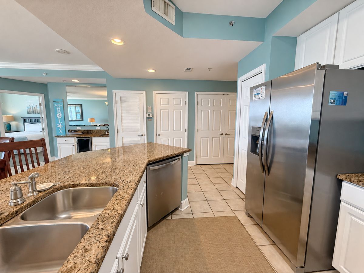 A kitchen with granite countertops, stainless steel appliances, and a tiled backsplash.