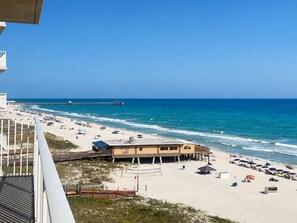 A beach with a building labeled 'Suds' and a pier in the background.