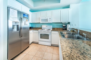 Enjoy cooking and dining in this well-equipped kitchen with a double sink and stainless steel appliances.