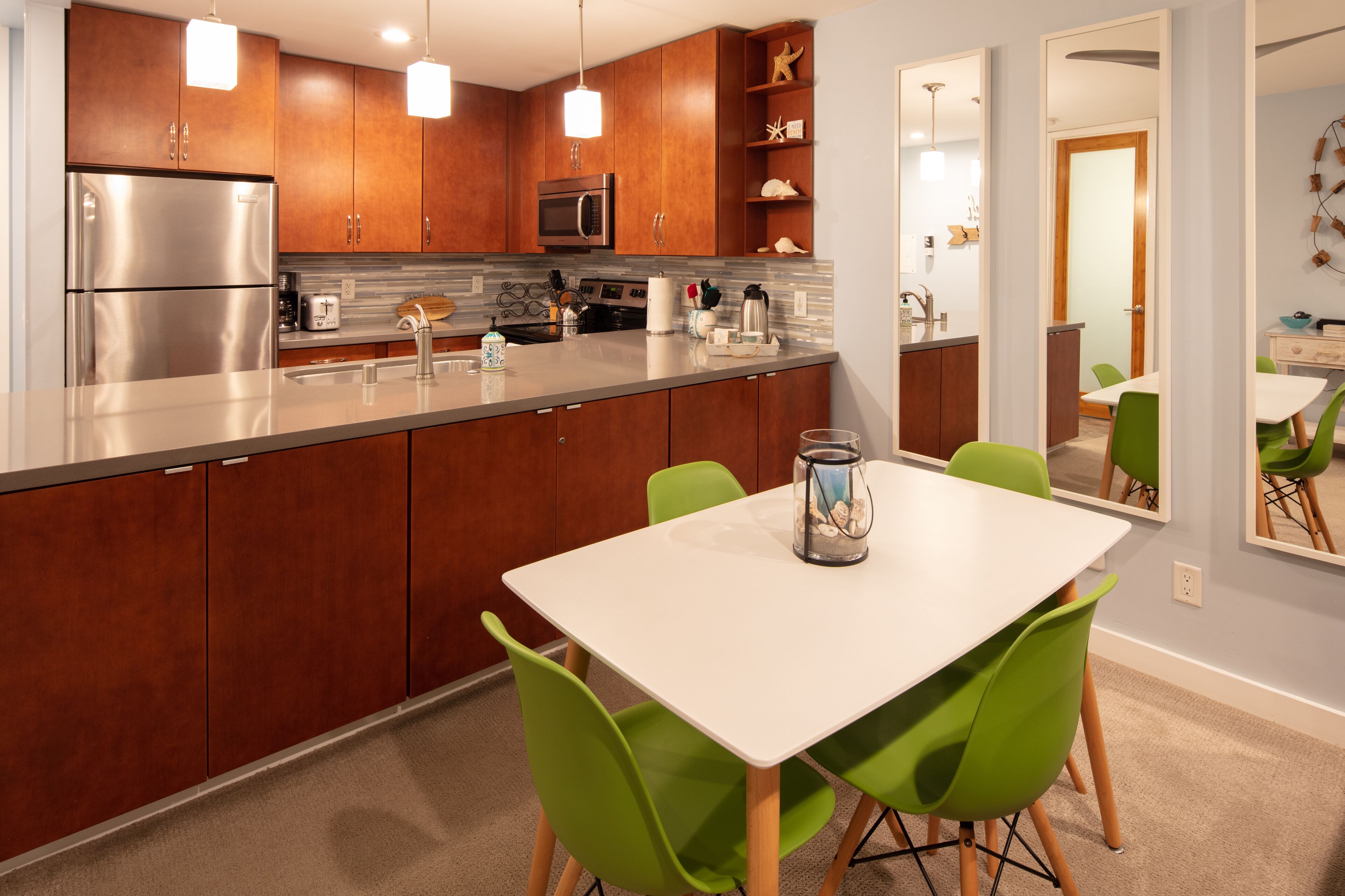 A modern kitchen with wooden cabinets, stainless steel appliances, and a white island.