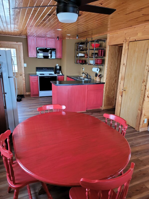 A kitchen with wooden cabinets, a stove, and a sink.