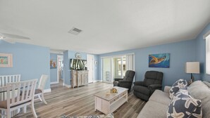 A living room with a dining area, a kitchen, and a bedroom. - Island House Beach Resort V33 (Siesta Key)
