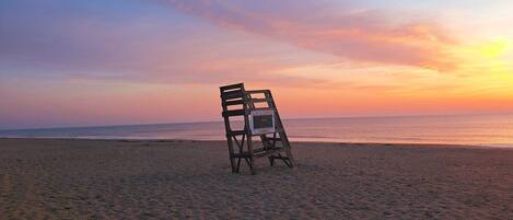 A beach with a lifeguard stand.