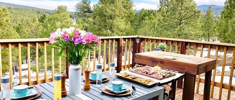 Enjoy a romantic meal on this deck overlooking the forest, surrounded by nature's serenity.