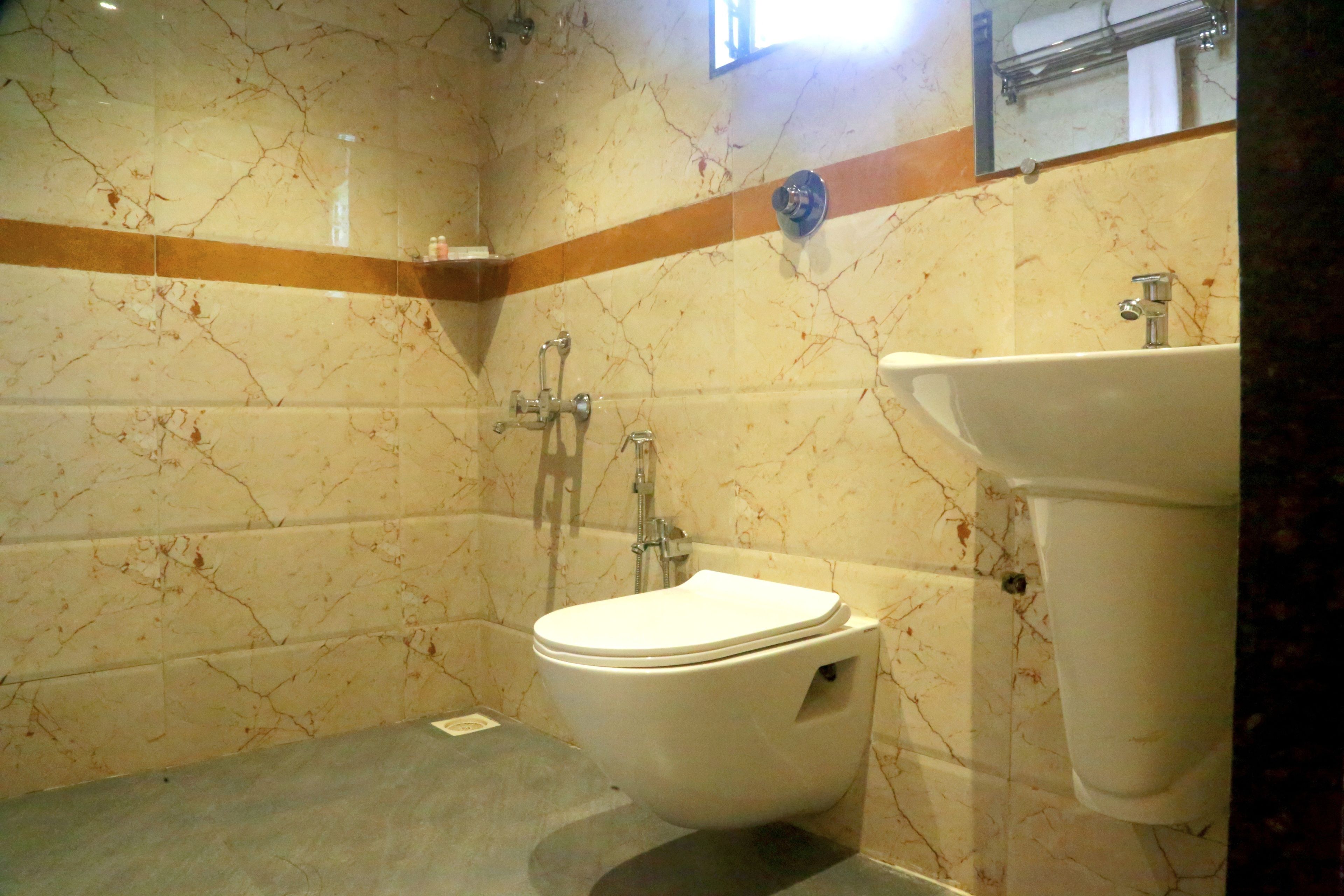 Un baño con inodoro, lavamanos y ducha.