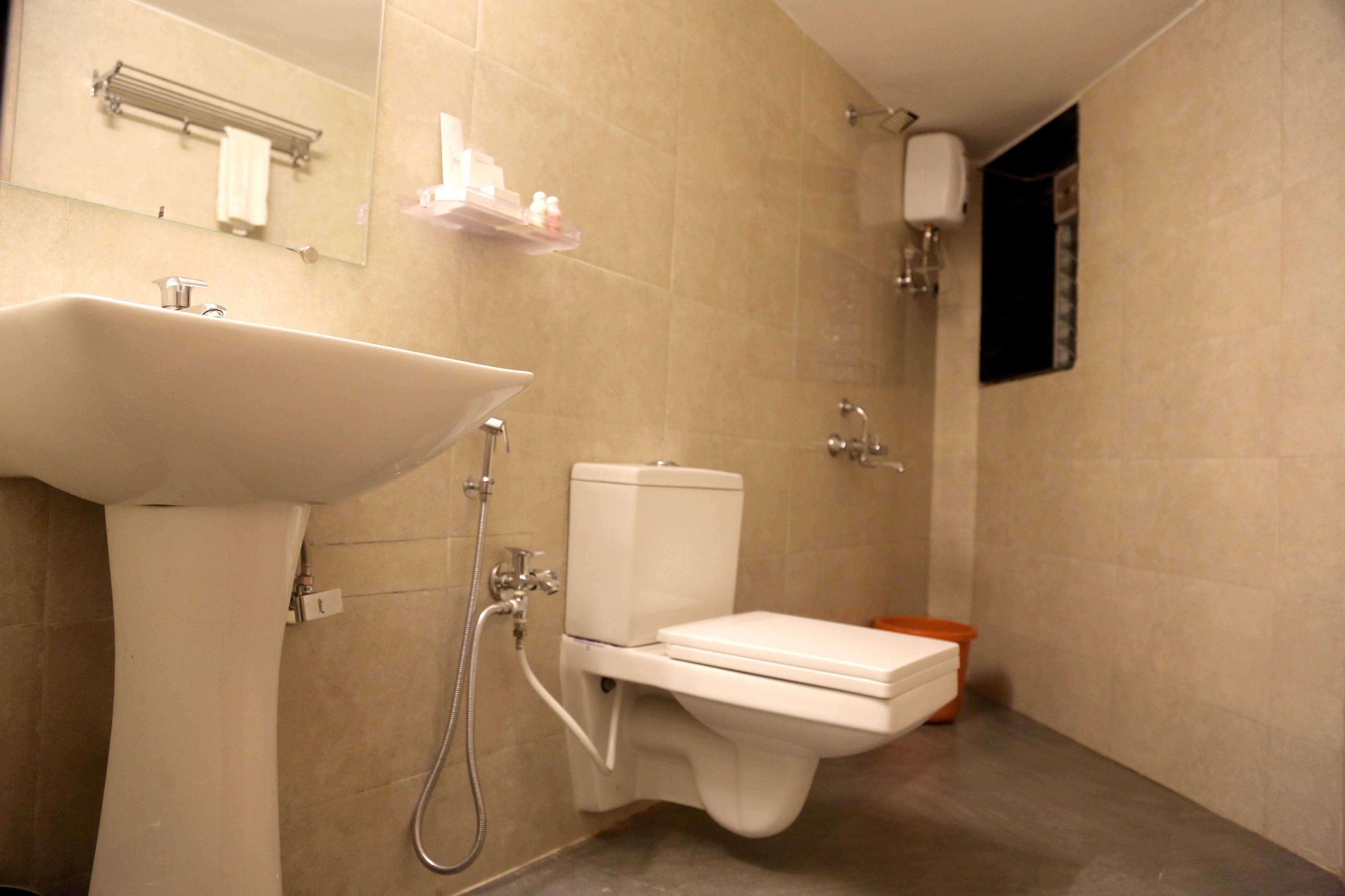 A bathroom with a sink, toilet, and shower.