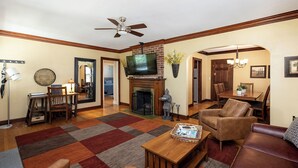 A living room with a fireplace, television, and seating area.