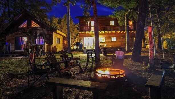 A cabin with a fire pit and outdoor seating. - Cabin on AuTrain River a few blocks from Lk Superior, 10 mi from Munising (Au Train)