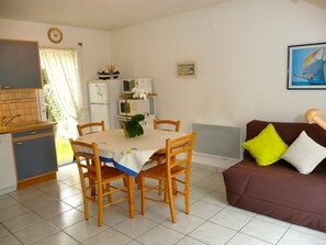 A compact living space with a dining area, kitchenette, and a sofa. - Your house loan of the sea. Beautiful decoration. (Baden)