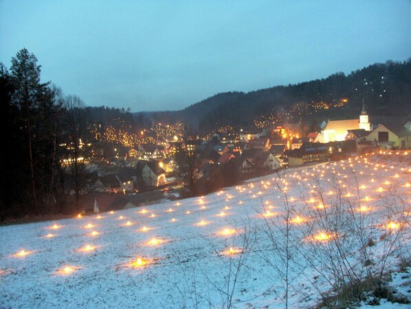 A snowy landscape with a village and a church.